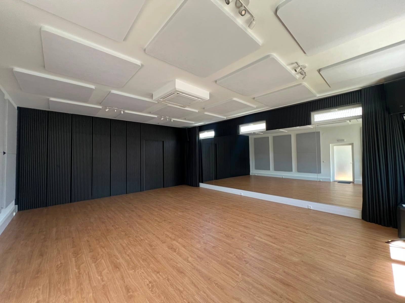 A sala, com a parede de espelho
